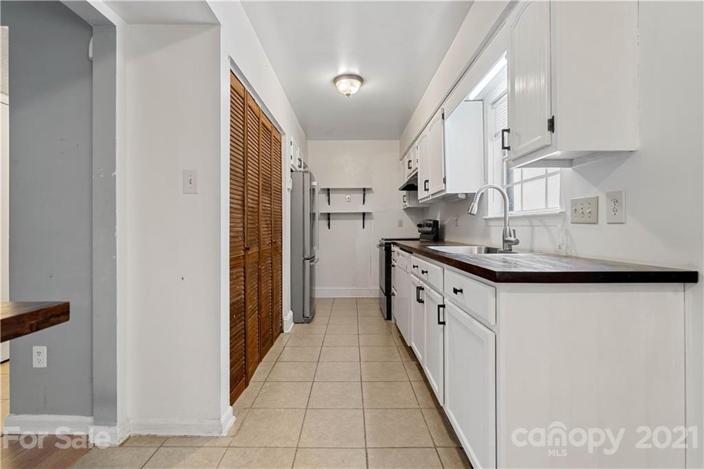 10953 Park Road Charlotte, NC 28226 - Photo 2 of 17 a kitchen with stainless steel appliances granite countertop a sink and cabinets