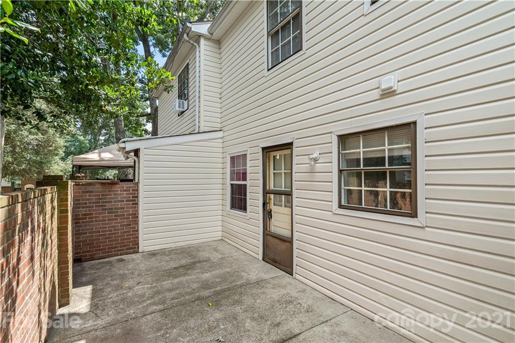 10953 Park Road Charlotte, NC 28226 - Photo 15 of 17 a view of a house with a window and brick walls