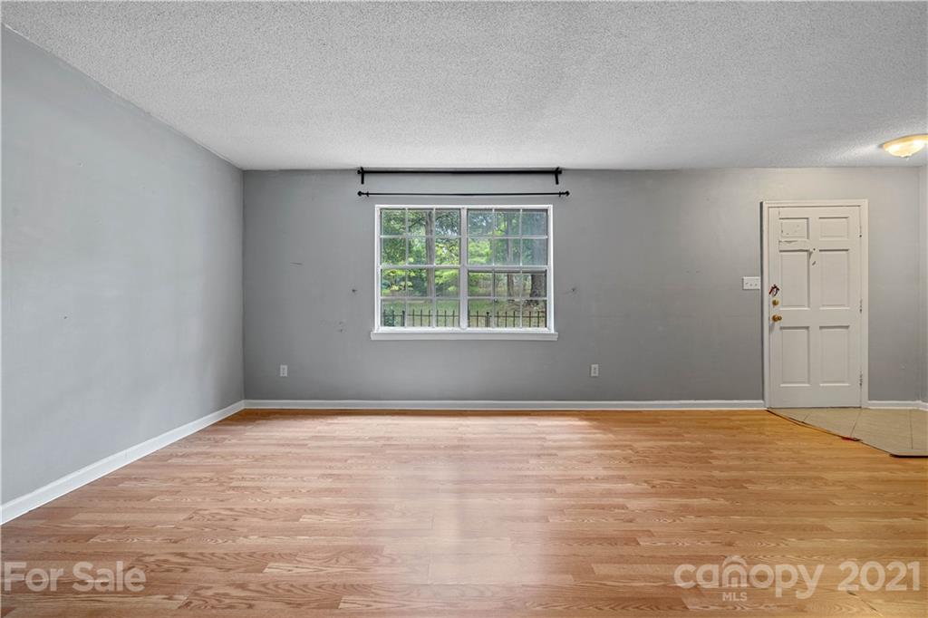 10953 Park Road Charlotte, NC 28226 - Photo 4 of 17 a view of an empty room with a window