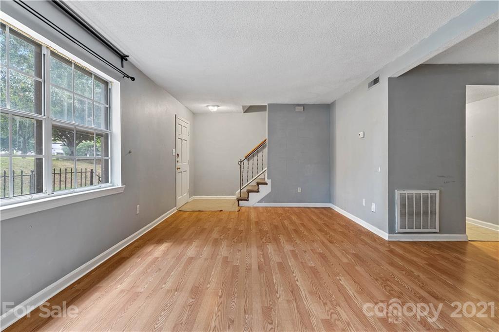 10953 Park Road Charlotte, NC 28226 - Photo 5 of 17 a view of an empty room with wooden floor and a window