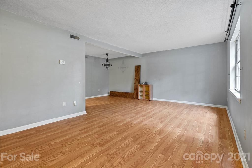 10953 Park Road Charlotte, NC 28226 - Photo 7 of 17 a view of empty room with wooden floor