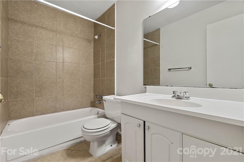 10953 Park Road Charlotte, NC 28226 - Photo 9 of 17 a bathroom with a sink a toilet and shower