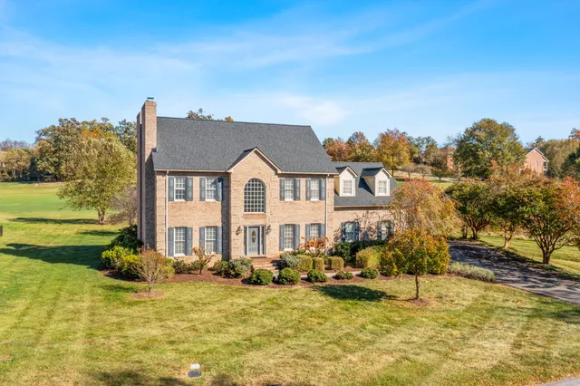 a view of a house with swimming pool and sitting area