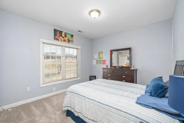 a bathroom with a sink mirror and toilet