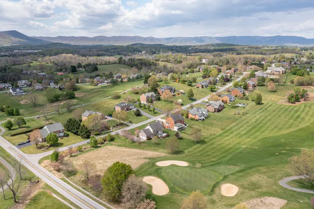 a view of a lake with couches and city view