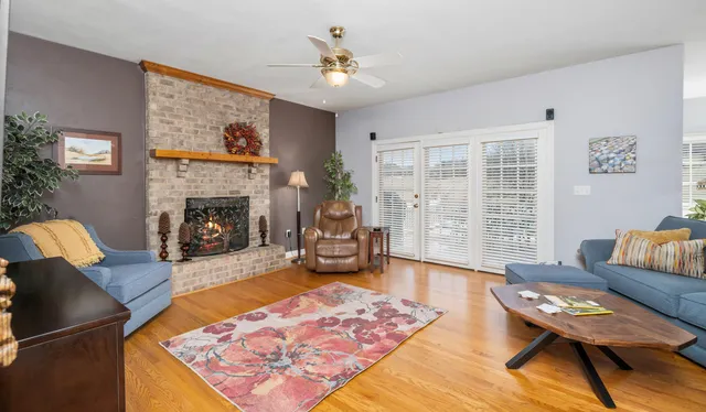 a living room with furniture a flat screen tv and a fireplace