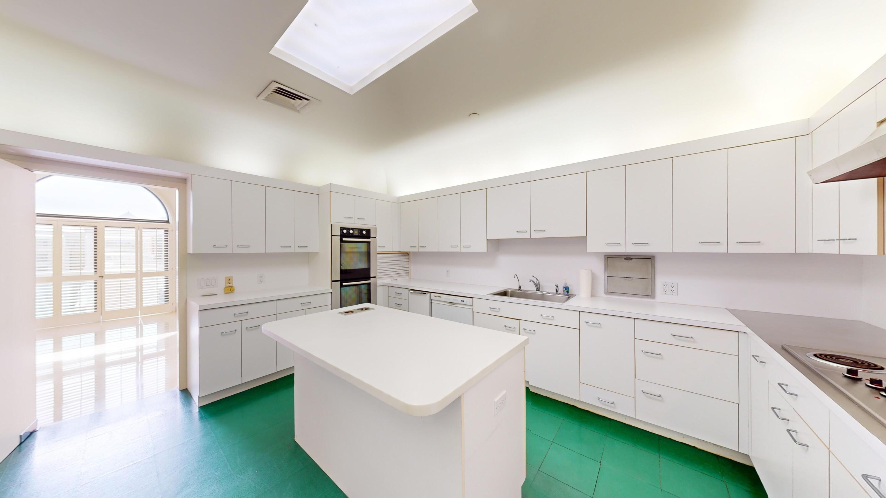 2 North Breakers Row, Unit PH4 Palm Beach, FL 33480 - Photo 24 of 38 a kitchen with white cabinets and white appliances