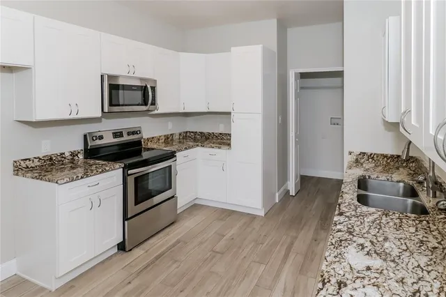 a kitchen with a stove and a microwave
