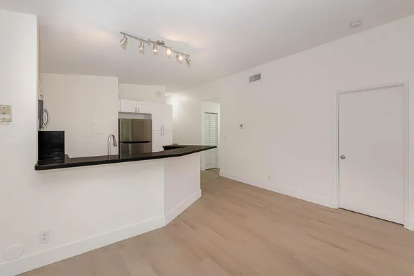 a view of a livingroom with wooden floor and windows