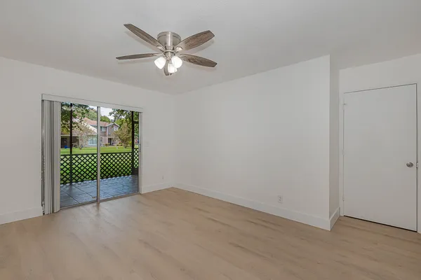 a view of an empty room with a ceiling fan