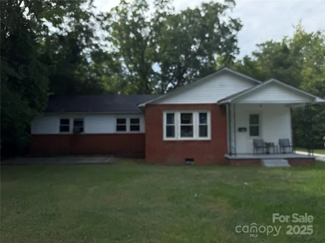 a front view of a house with a garden and yard
