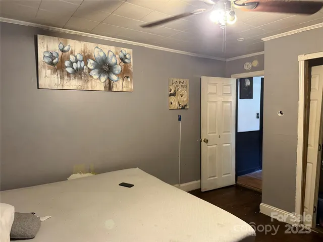 a bedroom with a bed and a painting on the wall