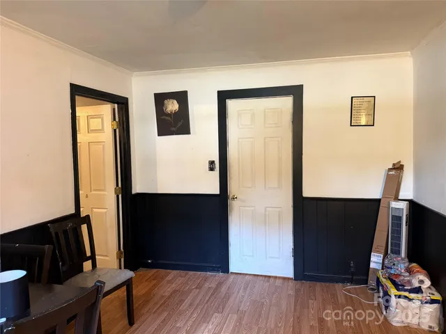 a view of a livingroom with wooden floor and a flat screen tv