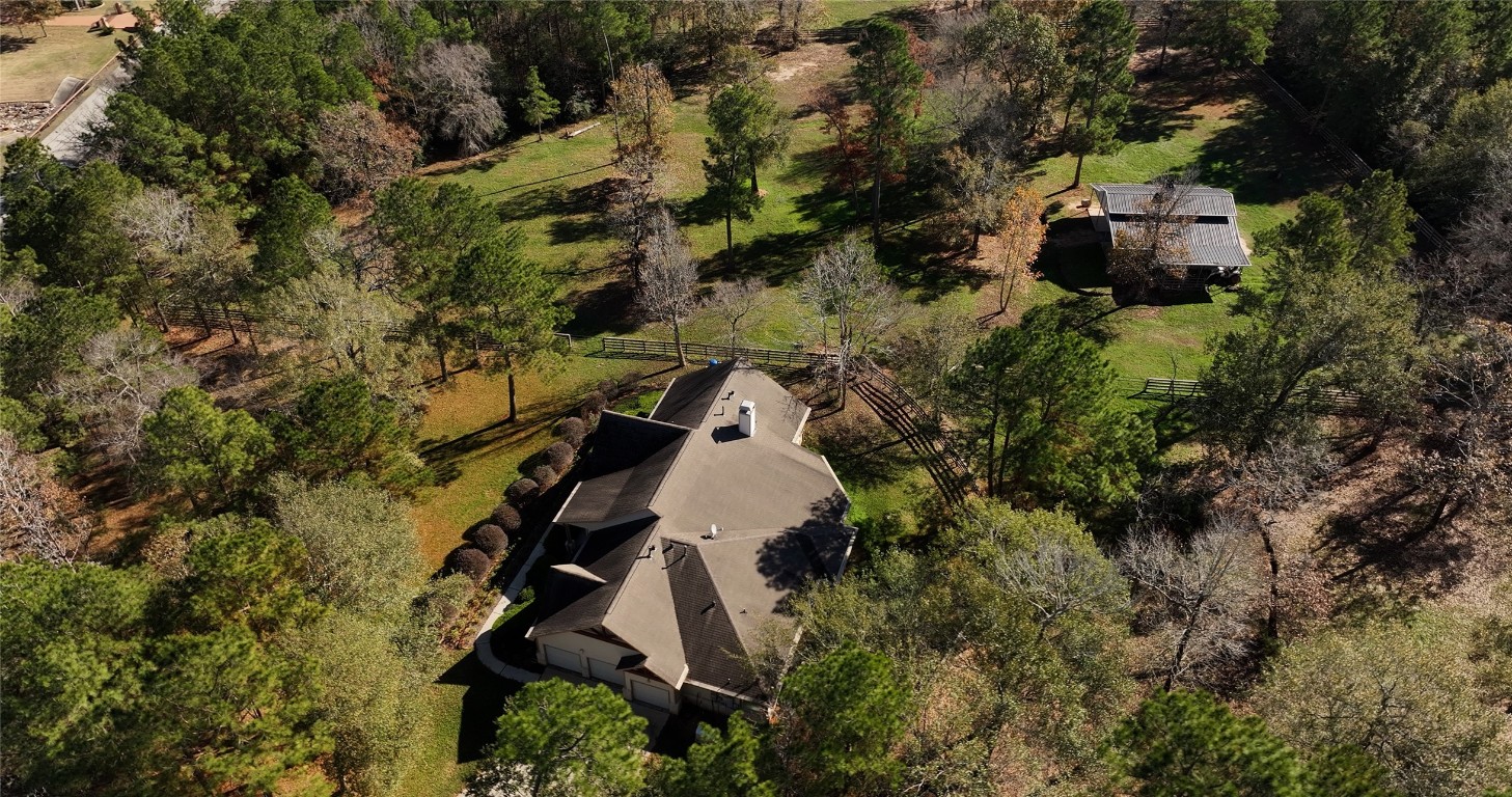 26173 Crown Ranch Boulevard Montgomery, TX 77316 - Photo 16 of 37 an aerial view of a house with a yard and trees all around