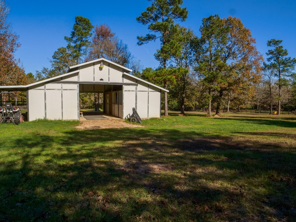 26173 Crown Ranch Boulevard Montgomery, TX 77316 - Photo 20 of 37 a front view of a house with a garden
