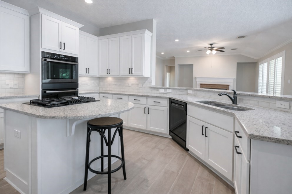 26173 Crown Ranch Boulevard Montgomery, TX 77316 - Photo 25 of 37 a kitchen with cabinets appliances and a sink