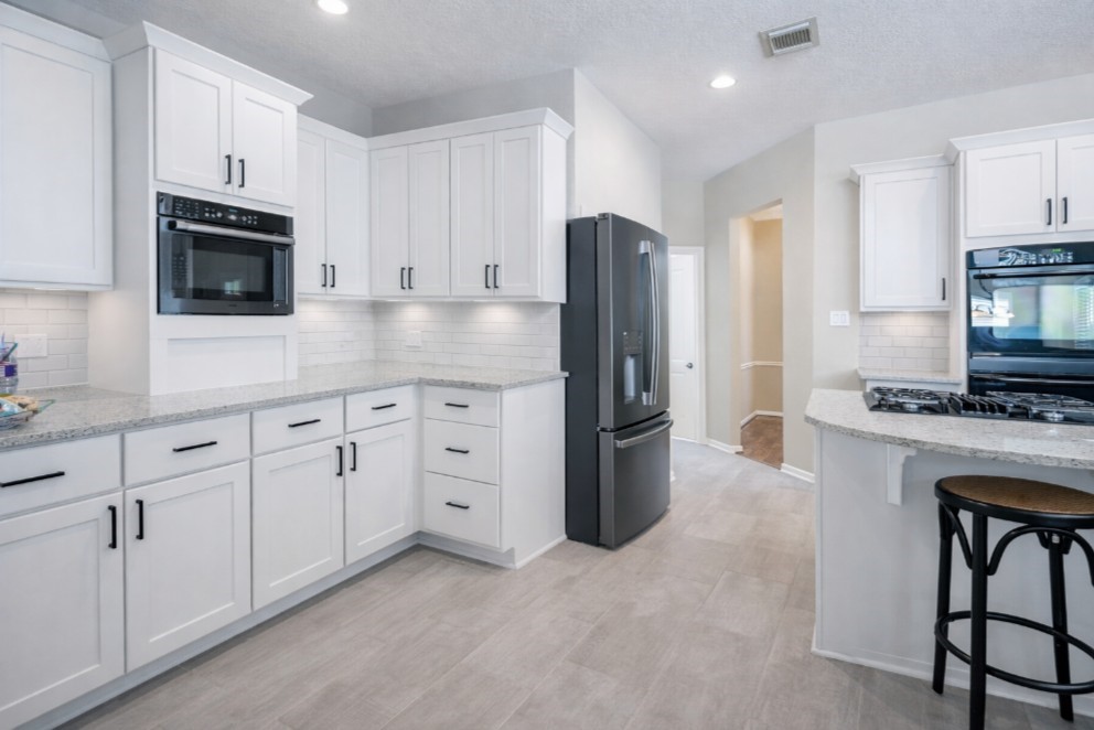 26173 Crown Ranch Boulevard Montgomery, TX 77316 - Photo 27 of 37 a kitchen with cabinets stainless steel appliances and a counter space