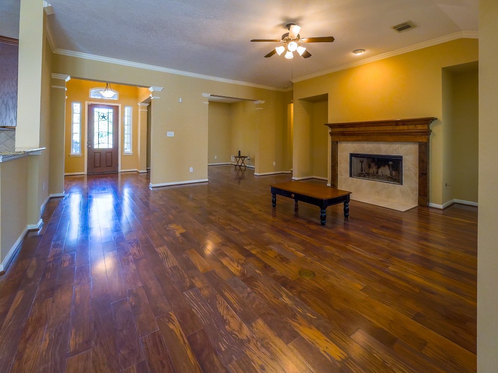 26173 Crown Ranch Boulevard Montgomery, TX 77316 - Photo 30 of 37 a living room with furniture and a fireplace