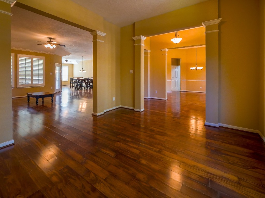 26173 Crown Ranch Boulevard Montgomery, TX 77316 - Photo 31 of 37 a view of a hallway with wooden floor