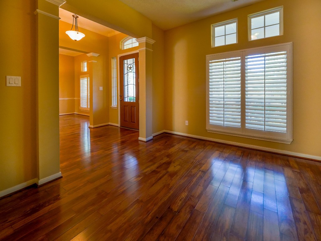 26173 Crown Ranch Boulevard Montgomery, TX 77316 - Photo 32 of 37 a view of an empty room with wooden floor and a window