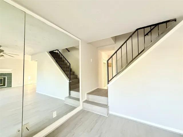 a view of entryway and hall with wooden floor