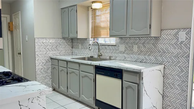 a kitchen with stainless steel appliances granite countertop a sink and a white cabinets