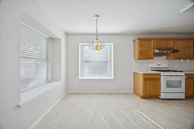 a kitchen with stove and window
