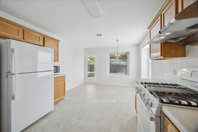 a kitchen with a stove a refrigerator and a stove