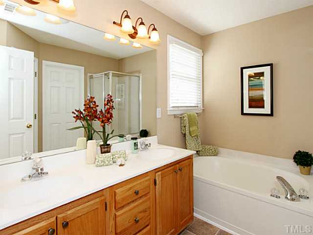 11213 North Radner Way Raleigh, NC 27613 - Photo 11 of 18 a bathroom with a tub sink and mirror