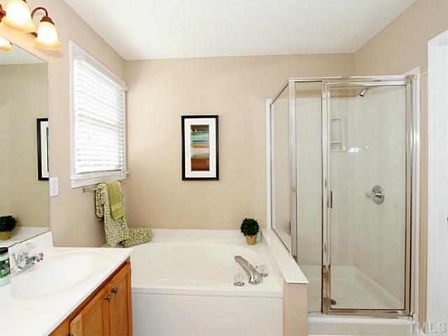 11213 North Radner Way Raleigh, NC 27613 - Photo 12 of 18 a bathroom with a tub sink and mirror