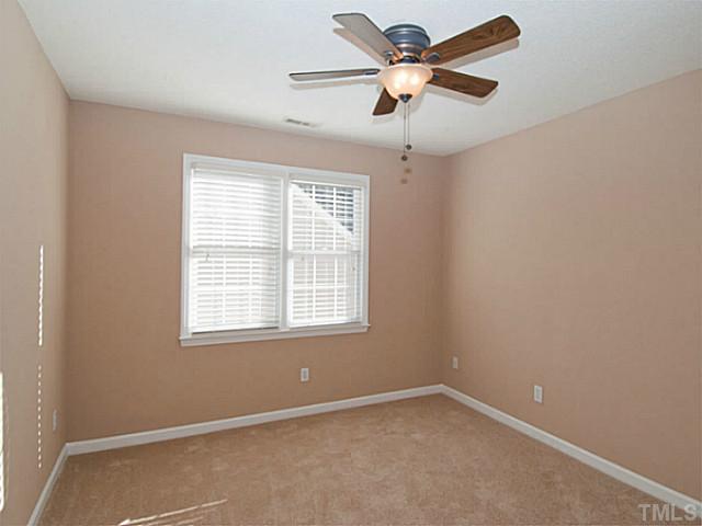 11213 North Radner Way Raleigh, NC 27613 - Photo 14 of 18 an empty room with a window and a fan