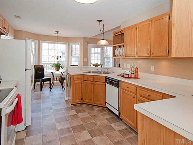 11213 North Radner Way Raleigh, NC 27613 - Photo 6 of 18 a kitchen with a sink stove and cabinets