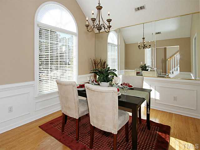 11213 North Radner Way Raleigh, NC 27613 - Photo 9 of 18 a dining room with furniture a chandelier and wooden floor