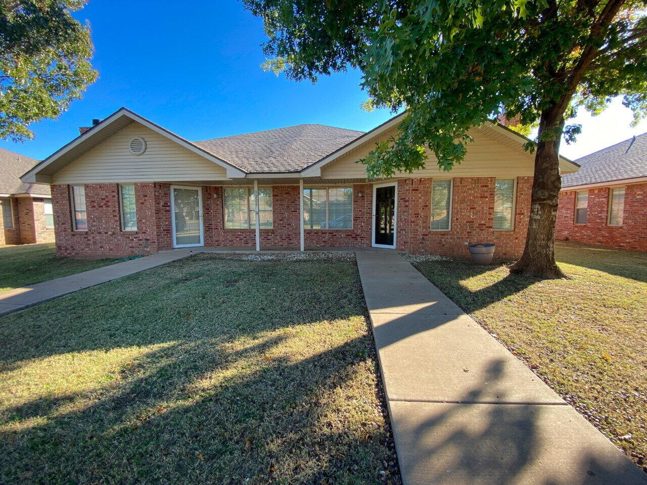 3209 110th Street, Unit B Lubbock, TX 79423 - Photo 1 of 7 a view of a yard in front of a house