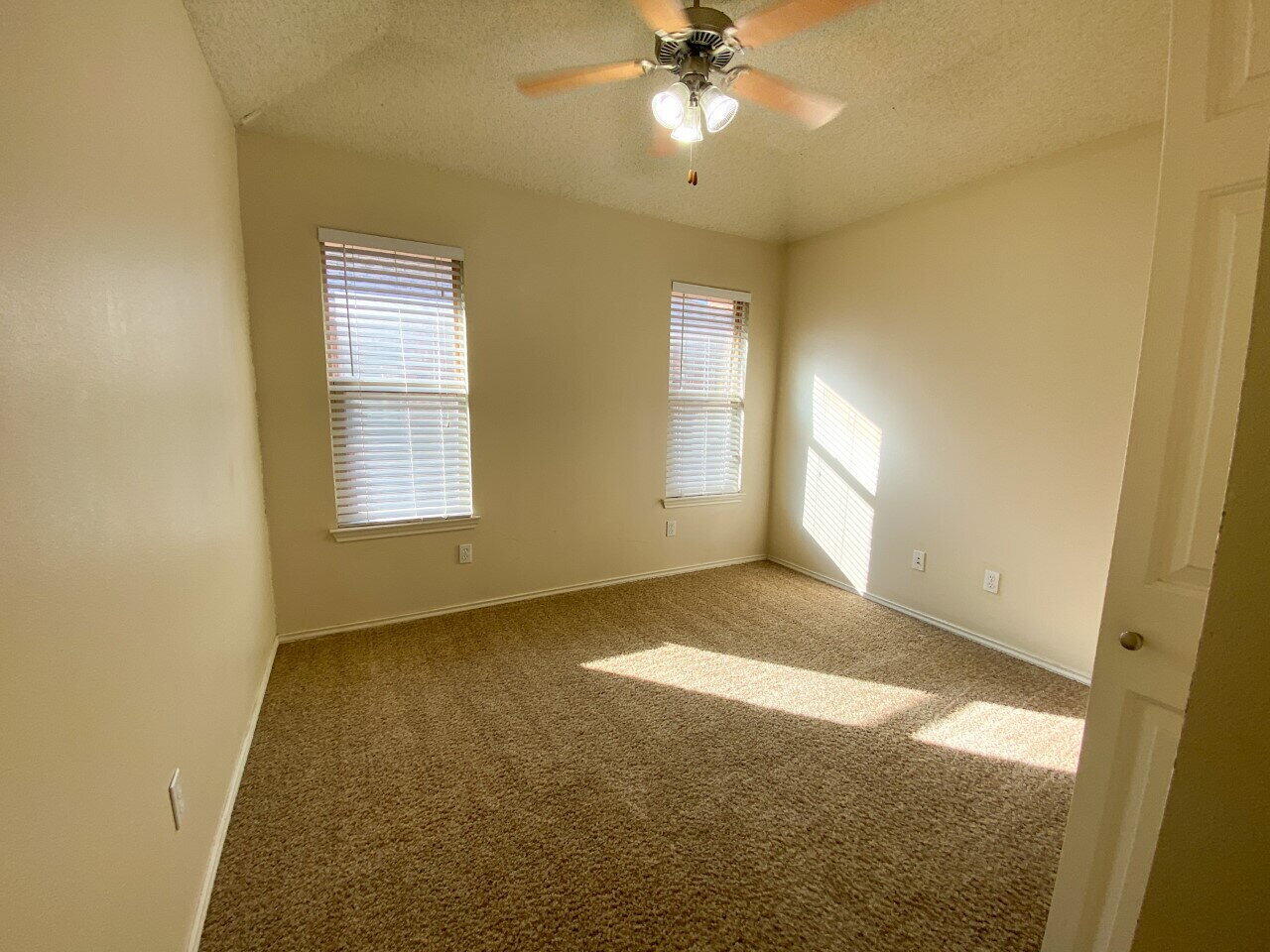 3209 110th Street, Unit B Lubbock, TX 79423 - Photo 6 of 7 a view of an empty room with a window