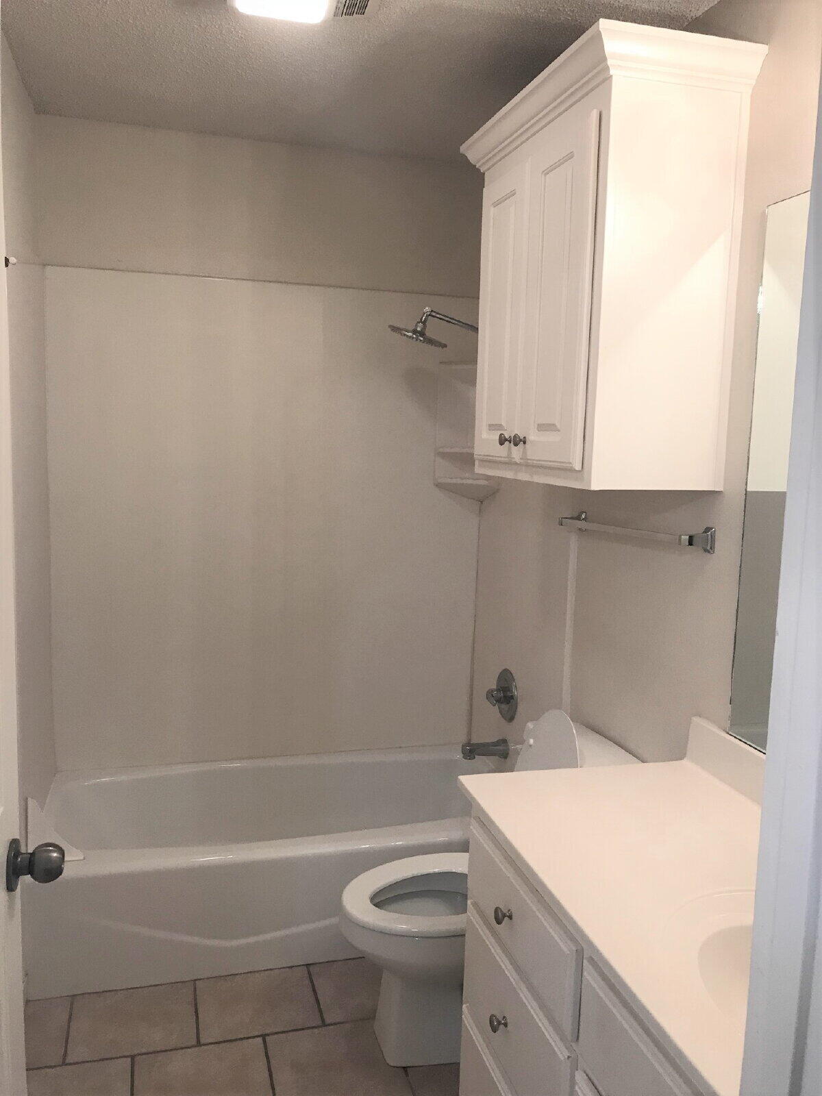 3209 110th Street, Unit B Lubbock, TX 79423 - Photo 7 of 7 a bathroom with a sink a toilet and a bathtub