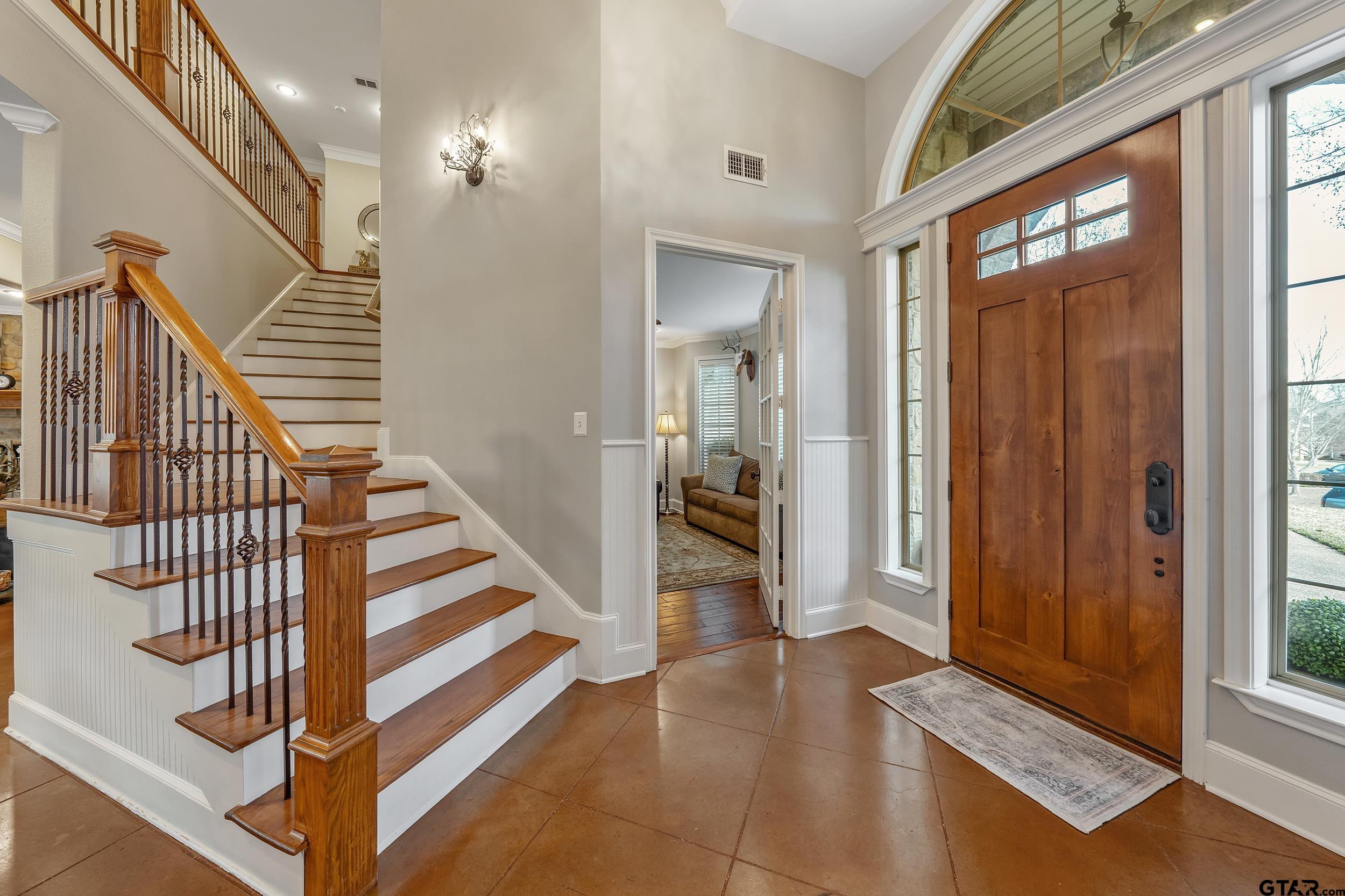 7752 Lamp Post Cove Tyler, TX 75703 - Photo 12 of 41 a view of a hallway with wooden floor and staircase