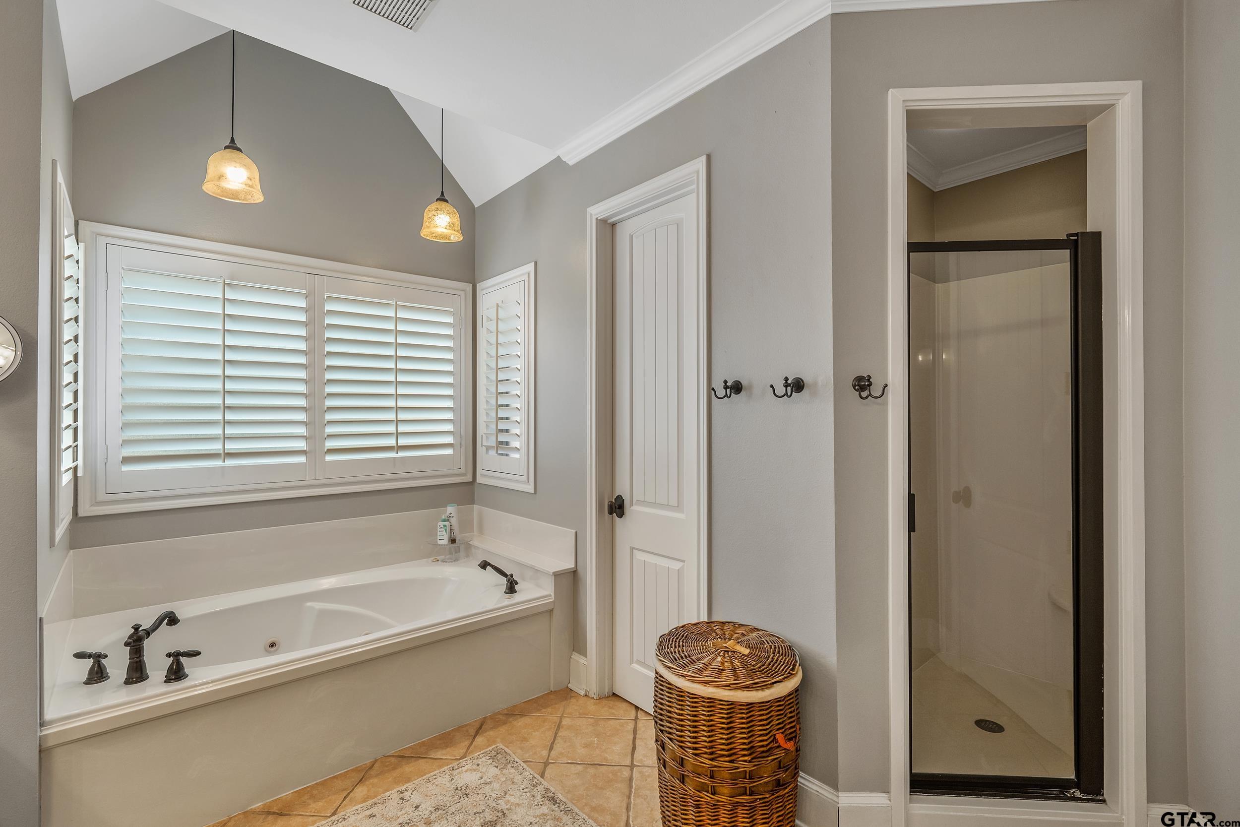7752 Lamp Post Cove Tyler, TX 75703 - Photo 19 of 41 a bathroom with a tub and a shower