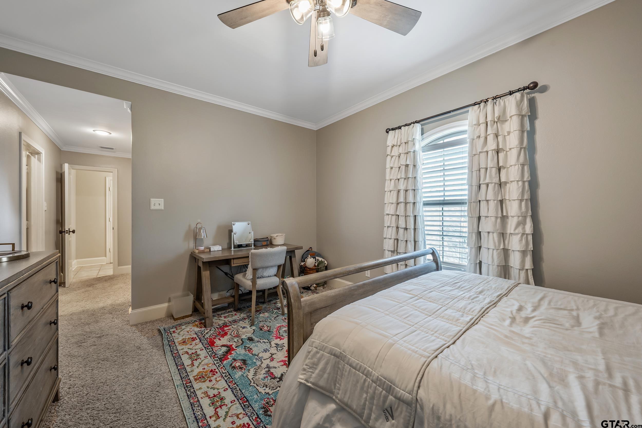 7752 Lamp Post Cove Tyler, TX 75703 - Photo 24 of 41 a bedroom with a bed and a chandelier