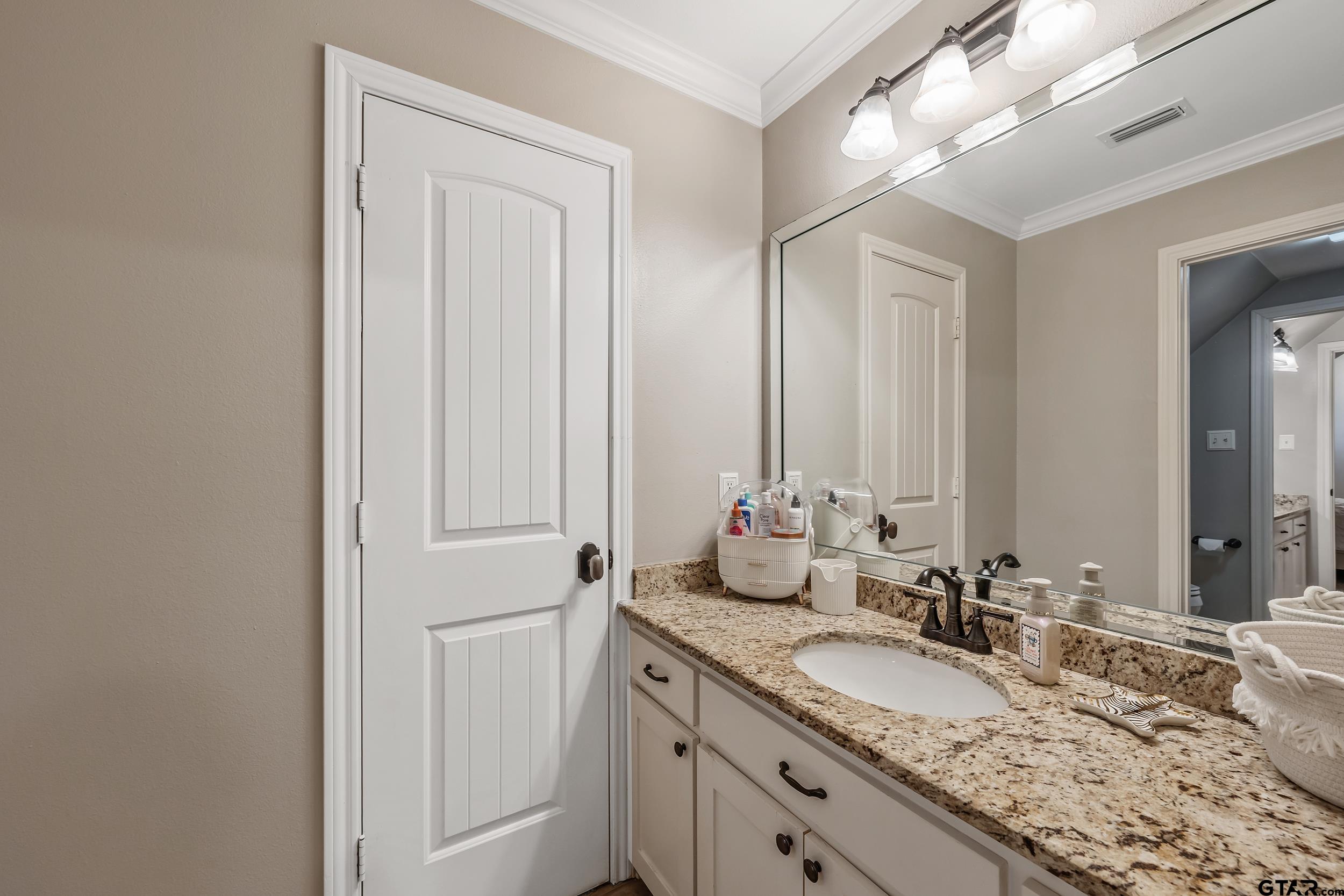 7752 Lamp Post Cove Tyler, TX 75703 - Photo 25 of 41 a bathroom with a granite countertop sink and a mirror
