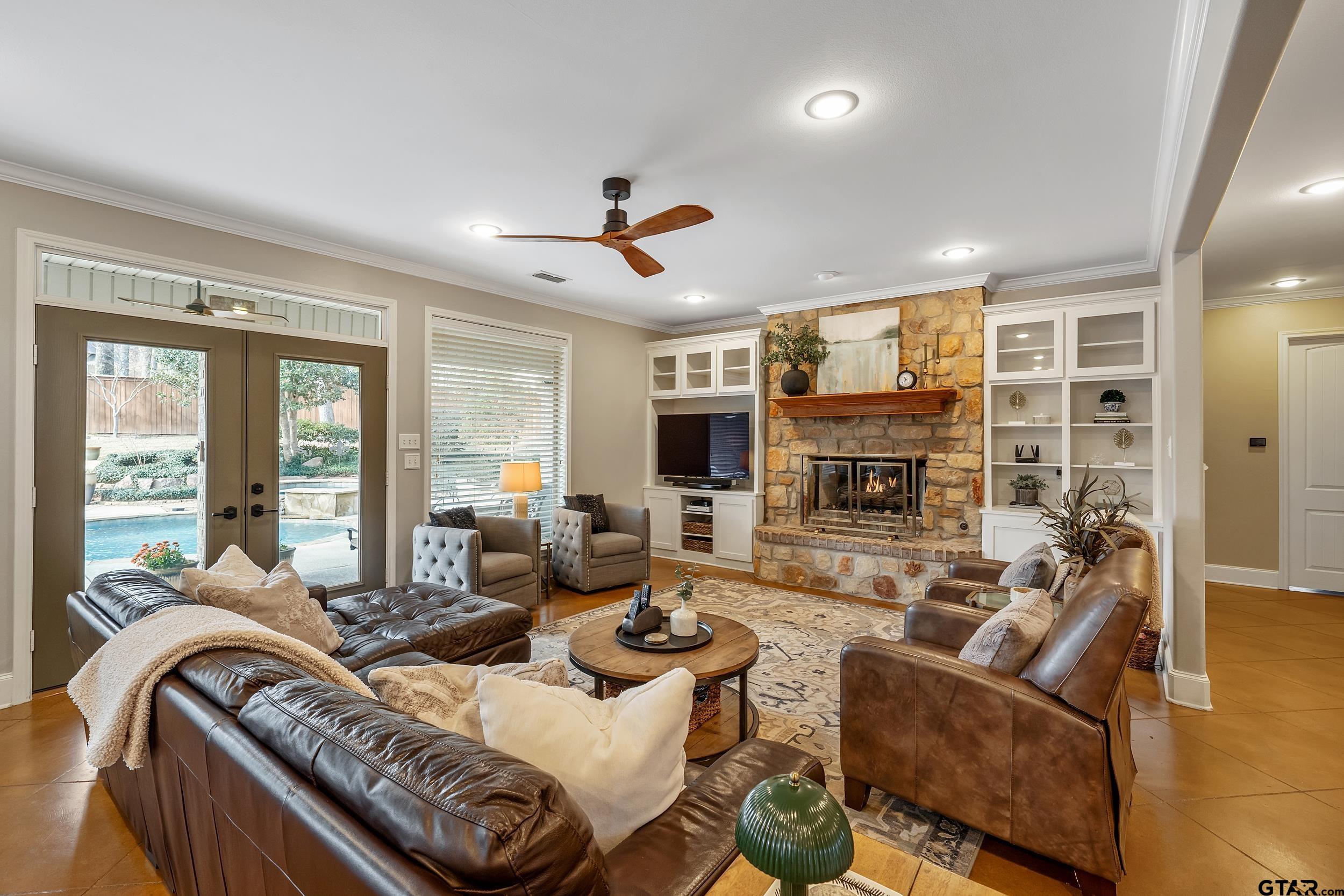 7752 Lamp Post Cove Tyler, TX 75703 - Photo 4 of 41 a living room with furniture ceiling fan and a fireplace