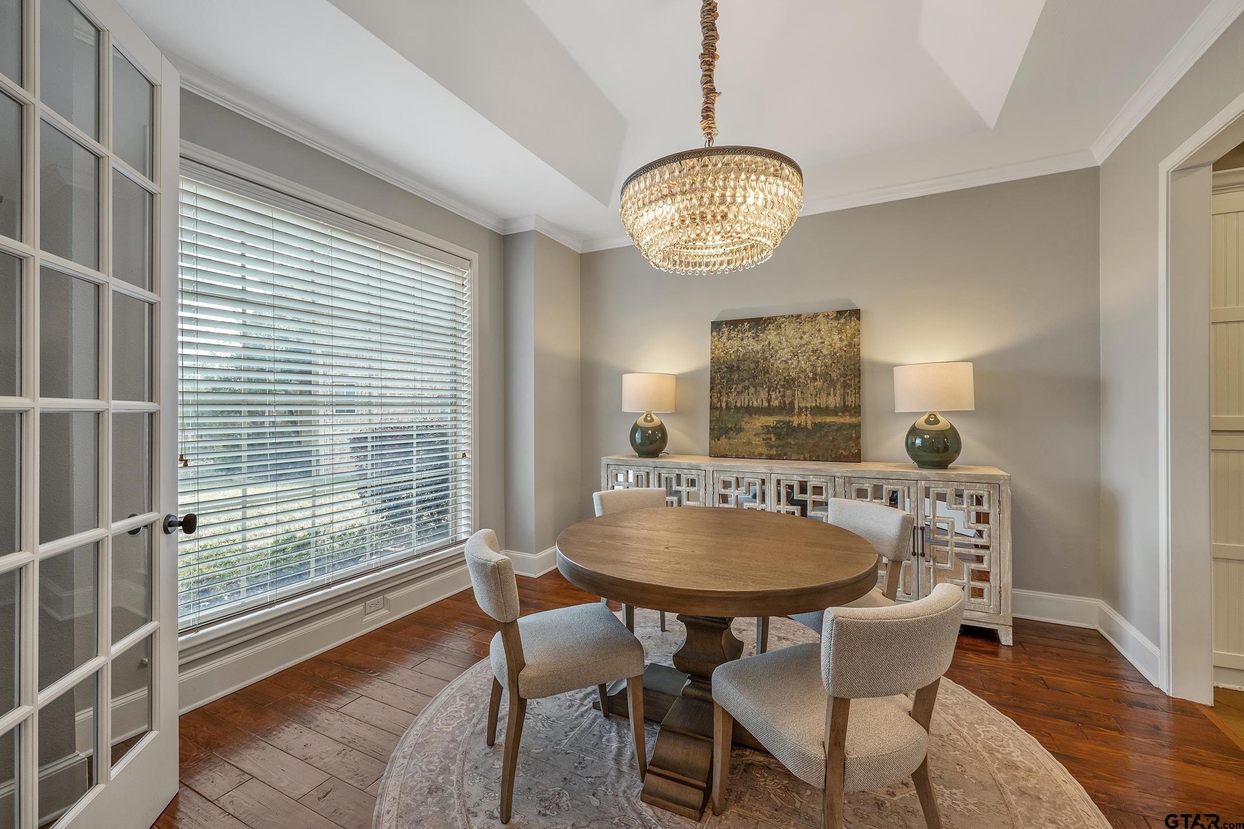 7752 Lamp Post Cove Tyler, TX 75703 - Photo 10 of 41 a dining room with furniture a chandelier and wooden floor