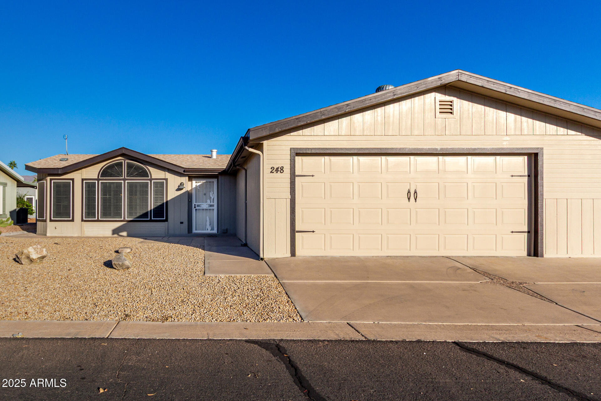 2400 East Baseline Road, Unit 248 Apache Junction, AZ 85119 - Photo 2 of 33 a front view of a house with a outdoor space