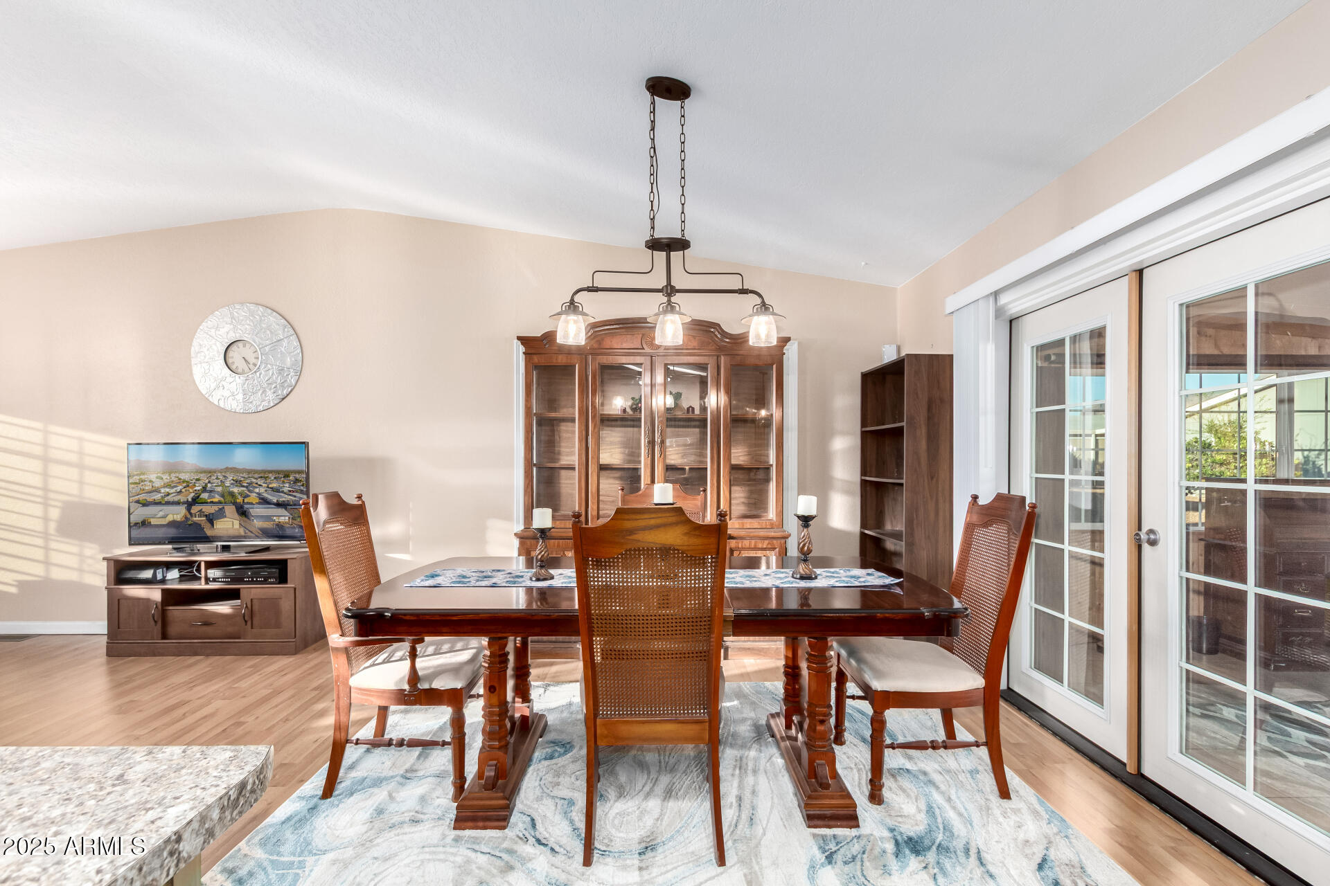 2400 East Baseline Road, Unit 248 Apache Junction, AZ 85119 - Photo 7 of 33 a dining room with furniture wooden floor and a chandelier