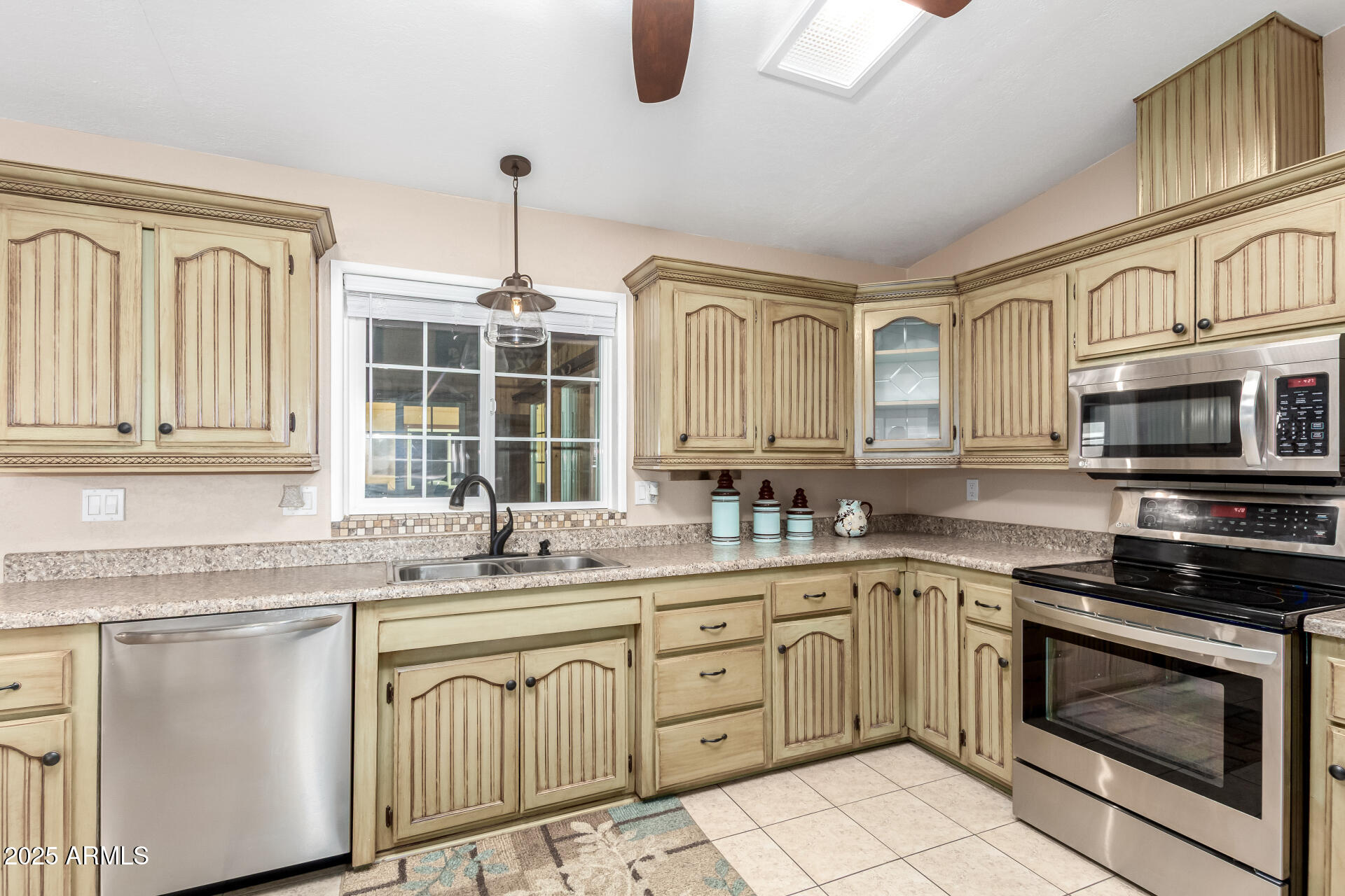 2400 East Baseline Road, Unit 248 Apache Junction, AZ 85119 - Photo 9 of 33 a kitchen with cabinets appliances a sink and a window