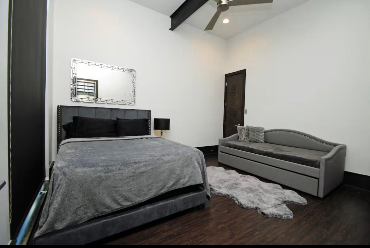 4118 Floyd Street, Unit A Houston, TX 77007 - Photo 21 of 25 a bedroom with a bed and wooden floor
