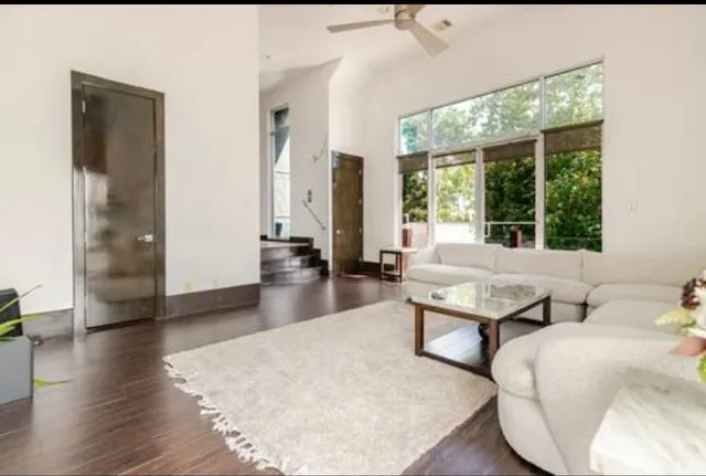a living room with furniture and large windows