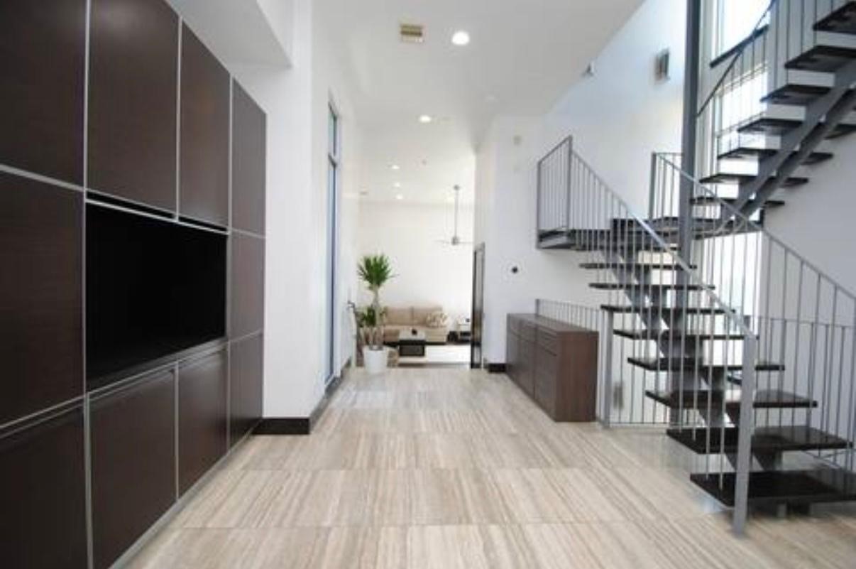 4118 Floyd Street, Unit A Houston, TX 77007 - Photo 5 of 25 a hallway with a white stove top oven and cabinets