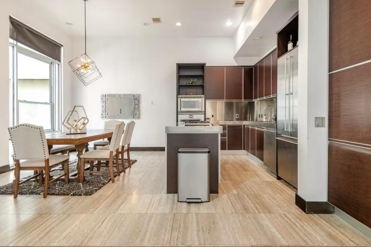 4118 Floyd Street, Unit A Houston, TX 77007 - Photo 7 of 25 a kitchen with kitchen island a counter top space a sink stainless steel appliances and cabinets