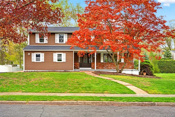 a view of a house with a yard and sitting area